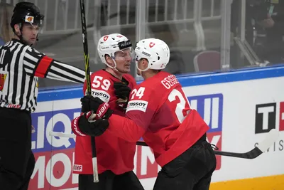 Dario Simion, left, and Tobias Geisser of Switzerland, celebrate a goal during the group B match between Switzerland and Kazakhstan at the ice hockey world championship in Riga, Latvia, Tuesday, May 16, 2023. (AP Photo/Roman Koksarov)