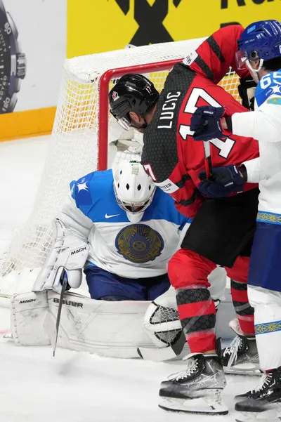 Milan Lucic of Canada, right, fights for a puck with goalie Nikita Boyarkin of Kazakhstan during the group B match between Canada and Kazakhstan at the ice hockey world championship in Riga, Latvia, Wednesday, May 17, 2023. (AP Photo/Roman Koksarov)