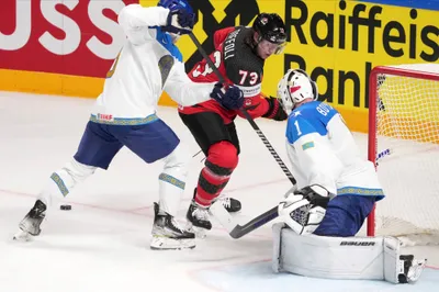 Tyler Toffoli of Canada, centre, fights for a puck with goalie Nikita Boyarkin of Kazakhstan during the group B match between Canada and Kazakhstan at the ice hockey world championship in Riga, Latvia, Wednesday, May 17, 2023. (AP Photo/Roman Koksarov)