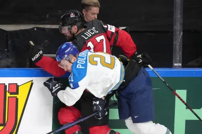 Milan Lucic of Canada, back, fights for a puck with Kirill Polokhov of Kazakhstan during the group B match between Canada and Kazakhstan at the ice hockey world championship in Riga, Latvia, Wednesday, May 17, 2023. (AP Photo/Roman Koksarov)