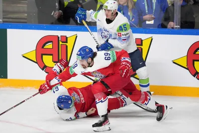 Daniel Vozelinek, front, and Martin Kaut of Czech Republic fight for a puck with Luka Maver of Slovenia during the group B match between Czech Republic and Slovenia at the ice hockey world championship in Riga, Latvia, Thursday, May 18, 2023. (AP Photo/Roman Koksarov)