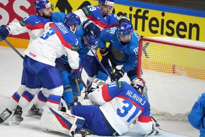 Team Slovakia players fight for a puck with team Kazakhstan playersduring the group B match between Slovakia and Kazakhstan at the ice hockey world championship in Riga, Latvia, Friday, May 19, 2023. (AP Photo/Roman Koksarov)