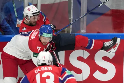 Eirik Salsten of Norway, back, fights for a puck with Tomas Dvorak of Czech Republic during the group B match between Norway and Czech Republic at the ice hockey world championship in Riga, Latvia, Saturday, May 20, 2023. (AP Photo/Roman Koksarov)