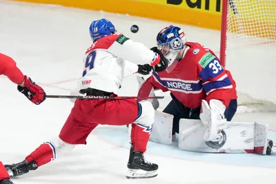 Goalie Henrik Haukeland of Norway, right, fights for a puck with Jakub Flek of Czech Republic during the group B match between Norway and Czech Republic at the ice hockey world championship in Riga, Latvia, Saturday, May 20, 2023. (AP Photo/Roman Koksarov)