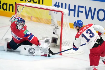 Goalie Henrik Haukeland of Norway, left, fights for a puck with Jiri Smejkal of Czech Republic during the group B match between Norway and Czech Republic at the ice hockey world championship in Riga, Latvia, Saturday, May 20, 2023. (AP Photo/Roman Koksarov)