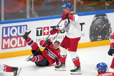 Ken Andre Olimb of Norway, left, fights for a puck with Jan Kostalek of Czech Republic during the group B match between Norway and Czech Republic at the ice hockey world championship in Riga, Latvia, Saturday, May 20, 2023. (AP Photo/Roman Koksarov)