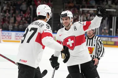 Nico Hischier of Switzerland, right, celebrates a goal during the group B match between Switzerland and Canada at the ice hockey world championship in Riga, Latvia, Saturday, May 20, 2023. (AP Photo/Roman Koksarov)