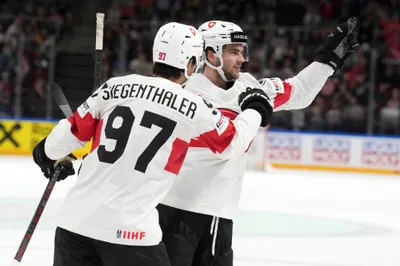 Nico Hischier of Switzerland, right, celebrates a goal with Jonas Siegenthaler during the group B match between Switzerland and Canada at the ice hockey world championship in Riga, Latvia, Saturday, May 20, 2023. (AP Photo/Roman Koksarov)