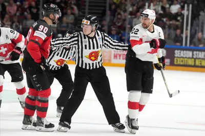 Nino Niederreiter of Switzerland, right, talks to Joseph Veleno of Canada during the group B match between Switzerland and Canada at the ice hockey world championship in Riga, Latvia, Saturday, May 20, 2023. (AP Photo/Roman Koksarov)