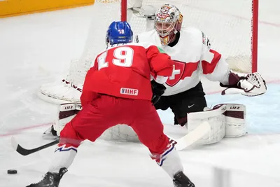 Jakub Flek of Czech Republic, left, fights for a puck with Robert Mayer of Switzerland during the group B match between Czech Republic and Switzerland at the ice hockey world championship in Riga, Latvia, Sunday, May 21, 2023. (AP Photo/Roman Koksarov)