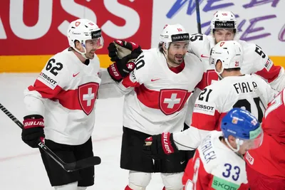 Andres Ambuhl of Switzerland, centre, celebrates a goal with teammates during the group B match between Czech Republic and Switzerland at the ice hockey world championship in Riga, Latvia, Sunday, May 21, 2023. (AP Photo/Roman Koksarov)