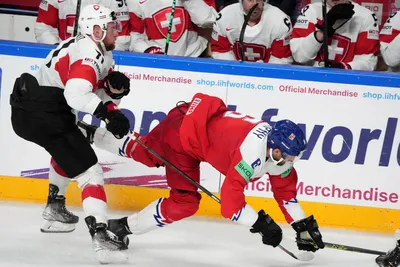 Michal Kempny of Czech Republic, right, fights for a puck with Tanner Richard of Switzerland during the group B match between Czech Republic and Switzerland at the ice hockey world championship in Riga, Latvia, Sunday, May 21, 2023. (AP Photo/Roman Koksarov)