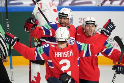 Andreas Martinsen of Norway, rear left, celebrates a goal with Mathias Trettenes, right, and Isak Hansen, front, during the group B match between Canada and Norway at the ice hockey world championship in Riga, Latvia, Monday, May 22, 2023. (AP Photo/Roman Koksarov)