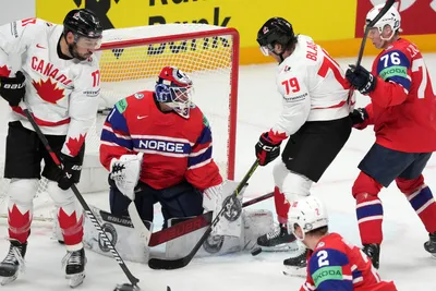 Canada's Samuel Blais, second right, and Milan Lucic, left, fight for a puck with goalie Tobias Normann of Norway during the group B match between Canada and Norway at the ice hockey world championship in Riga, Latvia, Monday, May 22, 2023. (AP Photo/Roman Koksarov)