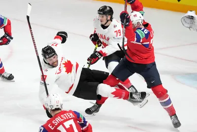 Milan Lucic of Canada, left, fights for a puck with Emil Lilleberg of Norway during the group B match between Canada and Norway at the ice hockey world championship in Riga, Latvia, Monday, May 22, 2023. (AP Photo/Roman Koksarov)