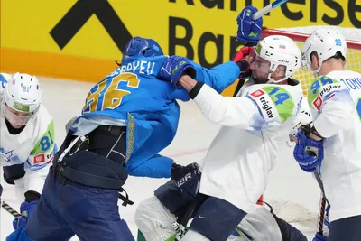 Abay Mangisbayev of Kazakhstan, left, fights for a puck with Matic Podlipnik of Slovenia during the group B match between Kazakhstan and Slovenia at the ice hockey world championship in Riga, Latvia, Monday, May 22, 2023. (AP Photo/Roman Koksarov)