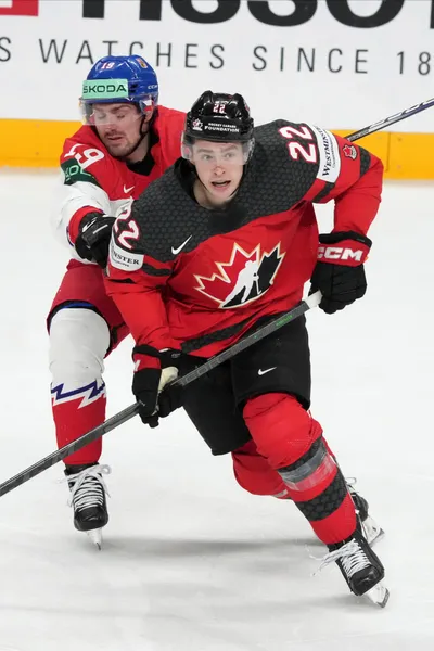 Jack Quinn of Canada, right, fights for a puck with Jakub Flek of Czech Republic during the group B match between Canada and Czech Republic at the ice hockey world championship in Riga, Latvia, Tuesday, May 23, 2023. (AP Photo/Roman Koksarov)