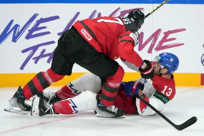 Tyler Myers of Canada, top, fights for a puck with Jiri Smejkal of Czech Republic during the group B match between Canada and Czech Republic at the ice hockey world championship in Riga, Latvia, Tuesday, May 23, 2023. (AP Photo/Roman Koksarov)