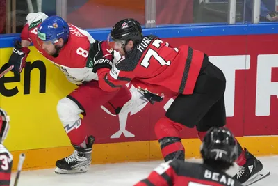 Brad Hunt of Canada, right, fights for a puck with Ondrej Beranek of Czech Republic during the group B match between Canada and Czech Republic at the ice hockey world championship in Riga, Latvia, Tuesday, May 23, 2023. (AP Photo/Roman Koksarov)