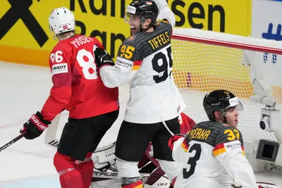 John Peterka, right, and Frederik Tiffels of Germany, celebrate a goal during the quarterfinal match between Germany and Switzerland at the ice hockey world championship in Riga, Latvia, Thursday, May 25, 2023. (AP Photo/Roman Koksarov)