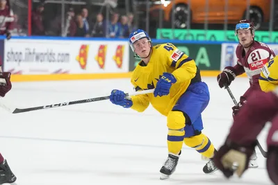Fabian Zetterlund of Sweden makes a shot during the quarter final match between Latvia and Sweden at the ice hockey world championship in Riga, Latvia, Thursday, May 25, 2023. (AP Photo/Roman Koksarov)