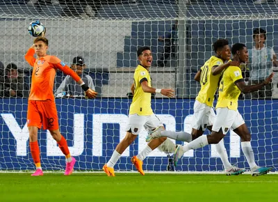 Ecuador's Justin Cuero, right, celebrates with teammates Nilson Angulo, second right, and Kendry Paez, center, after scoring his side's first goal against Slovakia, as Slovakia's goalkeeper Adam Hrdina, left, throws the ball, during a FIFA U-20 World Cup Group B soccer match at San Juan stadium in San Juan, Argentina, Tuesday, May 23, 2023. (AP Photo/Natacha Pisarenko).