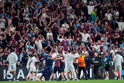 West Ham fans run on to the pitch to celebrate with the players at the end of the Europa Conference League final soccer match between Fiorentina and West Ham at the Eden Arena in Prague, Wednesday, June 7, 2023. West Ham won 2-1. (AP Photo/Petr David Josek)

- XCONFERENCELEAGUEX
