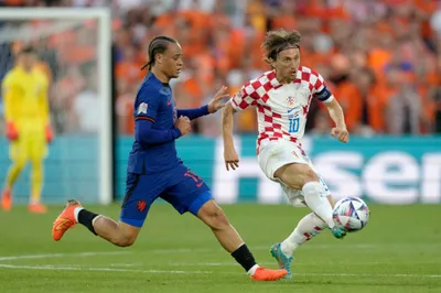 Netherlands' Xavi Simons vies for the ball with Croatia's Luka Modric, right, during the Nations League semifinal soccer match between the Netherlands and Croatia at De Kuip stadium in Rotterdam, Netherlands, Wednesday, June 14, 2023. (AP Photo/Peter Dejong)