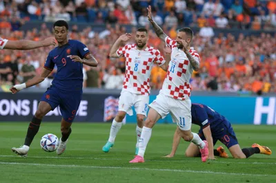 Netherlands' Cody Gakpo, left, controls the ball by Croatia's Marcelo Brozovic, right, during the Nations League semifinal soccer match between the Netherlands and Croatia at De Kuip stadium in Rotterdam, Netherlands, Wednesday, June 14, 2023. (AP Photo/Patrick Post)
