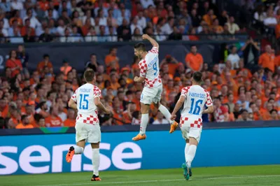 Croatia's Andrej Kramaric, center, celebrates after scoring from penalty against Netherlands during the Nations League semifinal soccer match between the Netherlands and Croatia at De Kuip stadium in Rotterdam, Netherlands, Wednesday, June 14, 2023. (AP Photo/Patrick Post)
