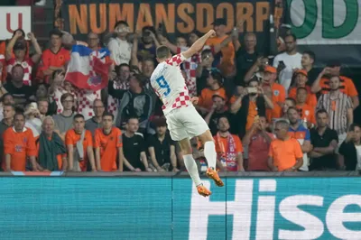 Croatia's Andrej Kramaric celebrates after scoring his side's first goal from the penalty spot during the Nations League semifinal soccer match between the Netherlands and Croatia at De Kuip stadium in Rotterdam, Netherlands, Wednesday, June 14, 2023. (AP Photo/Peter Dejong)