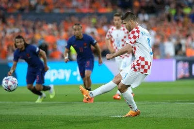 Croatia's Andrej Kramaric scores from penalty against Netherlands during the Nations League semifinal soccer match between the Netherlands and Croatia at De Kuip stadium in Rotterdam, Netherlands, Wednesday, June 14, 2023. (AP Photo/Patrick Post)