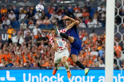 Netherlands' Nathan Ake fights for the ball with Croatia's Mario Pasalic, left, during the Nations League semifinal soccer match between the Netherlands and Croatia at De Kuip stadium in Rotterdam, Netherlands, Wednesday, June 14, 2023. (AP Photo/Peter Dejong)