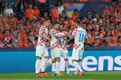 Croatia's Andrej Kramaric, center left, celebrates with his teammates after scoring from penalty against Netherlands during the Nations League semifinal soccer match between the Netherlands and Croatia at De Kuip stadium in Rotterdam, Netherlands, Wednesday, June 14, 2023. (AP Photo/Patrick Post)
