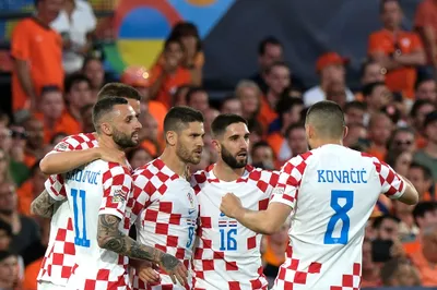 Croatia's Andrej Kramaric, center left, celebrates with his teammates after scoring from penalty against Netherlands during the Nations League semifinal soccer match between the Netherlands and Croatia at De Kuip stadium in Rotterdam, Netherlands, Wednesday, June 14, 2023. (AP Photo/Patrick Post)
