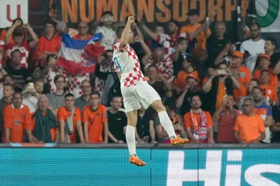 Croatia's Andrej Kramaric celebrates after scoring his side's first goal from the penalty spot during the Nations League semifinal soccer match between the Netherlands and Croatia at De Kuip stadium in Rotterdam, Netherlands, Wednesday, June 14, 2023. (AP Photo/Peter Dejong)
