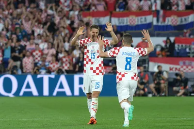 Croatia's Mario Pasalic, left, celebrates with his teammate Mateo Kovacic after scoring against Netherlands during the Nations League semifinal soccer match between the Netherlands and Croatia at De Kuip stadium in Rotterdam, Netherlands, Wednesday, June 14, 2023. (AP Photo/Patrick Post)