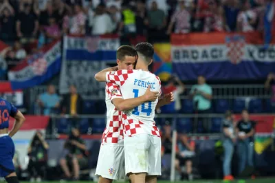Croatia's Mario Pasalic, left, celebrates with his teammate Ivan Perisic after scoring against Netherlands during the Nations League semifinal soccer match between the Netherlands and Croatia at De Kuip stadium in Rotterdam, Netherlands, Wednesday, June 14, 2023. (AP Photo/Patrick Post)