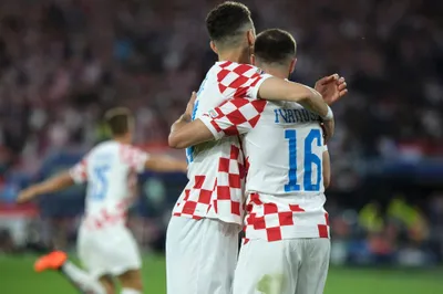 Croatia's Luka Ivanusec, right, and Ivan Perisic celebrate the second goal from their teammate Mario Pasalic, left, after scoring against Netherlands during the Nations League semifinal soccer match between the Netherlands and Croatia at De Kuip stadium in Rotterdam, Netherlands, Wednesday, June 14, 2023. (AP Photo/Patrick Post)