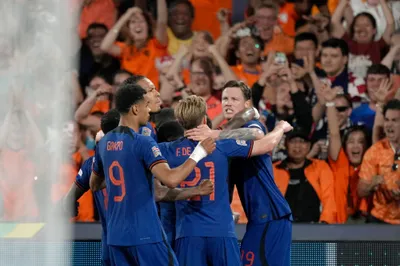 The Netherlands players celebrate after scoring their second goal during the Nations League semifinal soccer match between the Netherlands and Croatia at De Kuip stadium in Rotterdam, Netherlands, Wednesday, June 14, 2023. (AP Photo/Peter Dejong)