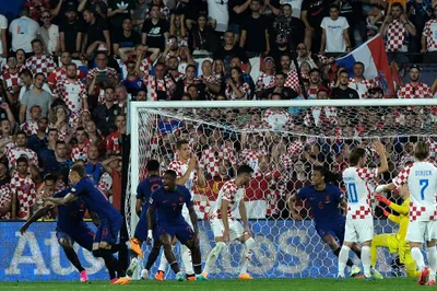Netherlands' Noa Lang, front left, celebrates after scoring against Netherlands during the Nations League semifinal soccer match between the Netherlands and Croatia at De Kuip stadium in Rotterdam, Netherlands, Wednesday, June 14, 2023. (AP Photo/Patrick Post)
