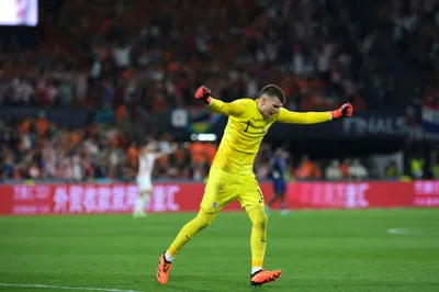 Croatia goalkeeper Dominik Livakovic celebrates after his teammate Bruno Petkovic scoring the third goal against Netherlands during the Nations League semifinal soccer match between the Netherlands and Croatia at De Kuip stadium in Rotterdam, Netherlands, Wednesday, June 14, 2023. (AP Photo/Patrick Post)