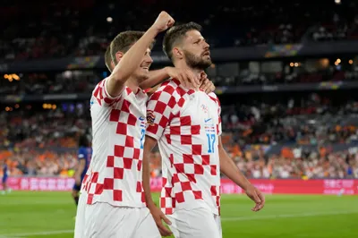Croatia's Bruno Petkovic, right, celebrates after scoring his side's third goal during the Nations League semifinal soccer match between the Netherlands and Croatia at De Kuip stadium in Rotterdam, Netherlands, Wednesday, June 14, 2023. (AP Photo/Peter Dejong)