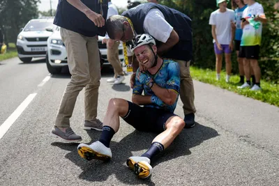 Britain's Mark Cavendish grimaces in pain as he receives medical assistance after crashing during the eighth stage of the Tour de France cycling race over 201 kilometers (125 miles) with start in Libourne and finish in Limoges, France, Saturday, July 8, 2023. (AP Photo/Thibault Camus)