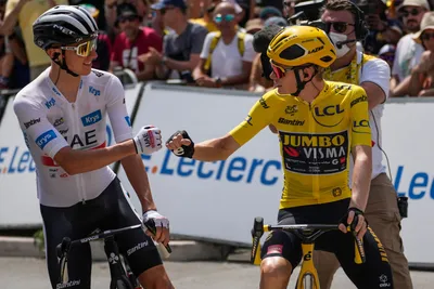 Denmark's Jonas Vingegaard, right, wearing the overall leader's yellow jersey, greets Slovenia's Tadej Pogacar ahead of the eighth stage of the Tour de France cycling race over 201 kilometers (125 miles) with start in Libourne and finish in Limoges, France, Saturday, July 8, 2023. (AP Photo/Thibault Camus)