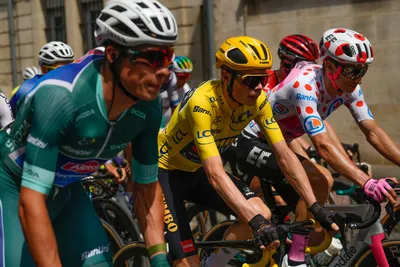 From left, Belgium's Jasper Philipsen , wearing the best sprinter's green jersey, Denmark's Jonas Vingegaard, wearing the overall leader's yellow jersey, and Neilson Powless of the U.S., wearing the best climber's dotted jersey, start the eighth stage of the Tour de France cycling race over 201 kilometers (125 miles) with start in Libourne and finish in Limoges, France, Saturday, July 8, 2023. (AP Photo/Thibault Camus)
