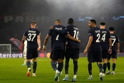 PSG's players celebrate after Randal Kolo Muani scored his side's second goal during the Champions League group F soccer match between Paris Saint Germain and AC Milan at Parc des Princes stadium in Paris, Wednesday, Oct. 25, 2023. (AP Photo/Thibault Camus)

- XCHAMPIONSLEAGUEX
