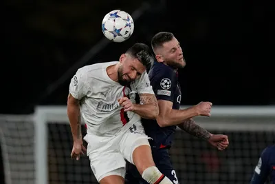 PSG's Milan Skriniar, right, jumps for the ball with AC Milan's Olivier Giroud during the Champions League group F soccer match between Paris Saint Germain and AC Milan at Parc des Princes stadium in Paris, Wednesday, Oct. 25, 2023. (AP Photo/Thibault Camus)

- XCHAMPIONSLEAGUEX