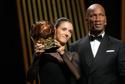 Former soccer star Didier Drogba, right, stands next to FC Barcelona's and Spain's national team's midfielder Aitana Bonmati as she receives the 2023 Women's Ballon d'Or award during the 67th Ballon d'Or (Golden Ball) award ceremony at Theatre du Chatelet in Paris, France, Monday, Oct. 30, 2023. (AP Photo/Michel Euler)