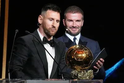 Inter Miami team co-owner and former soccer star David Beckham, right, smiles as Inter Miami's and Argentina's national team player Lionel Messi receives the 2023 Ballon d'Or trophy from during the 67th Ballon d'Or (Golden Ball) award ceremony at Theatre du Chatelet in Paris, France, Monday, Oct. 30, 2023. (AP Photo/Michel Euler)